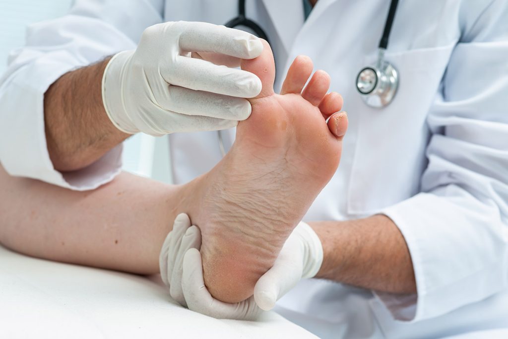 Doctor examining a toe's range of movement.